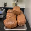Several plastic wrapped packages of methamphetamine on a scale