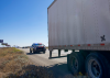 A marked AZDPS patrol vehicle stopped behind a tractor-trailer during Operation Southern Shield alongside I-10 near Casa Grande.